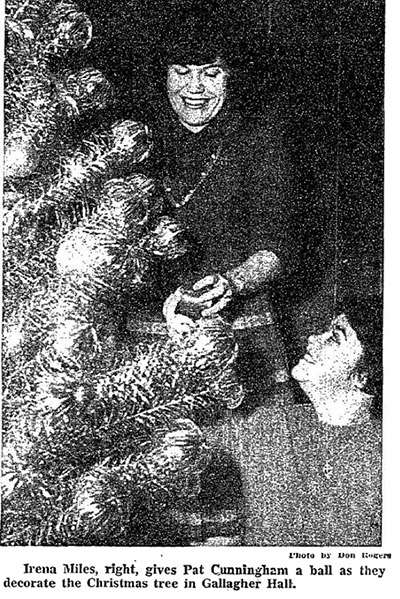 Students decorate a Christmas tree in the 1960s.
