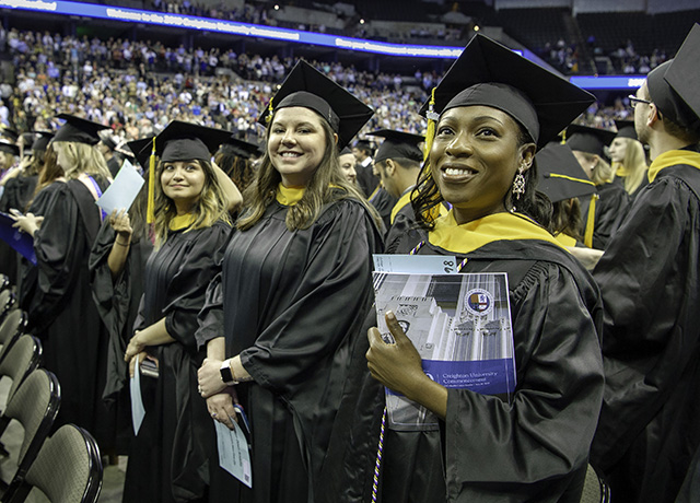 Graduates look on during commencement 2019