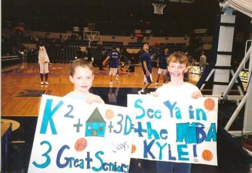 A photo from Creighton alum Laura Haller's childhood of her holding a Kyle Korver sign