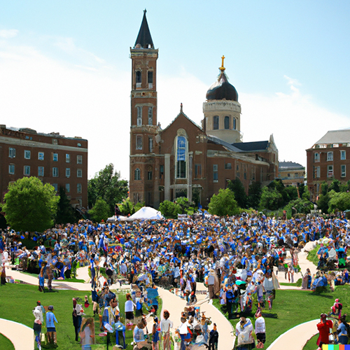 A crowd of Creighton alumni and Jesuits on the Mall celebrating what they love most about Creighton University.