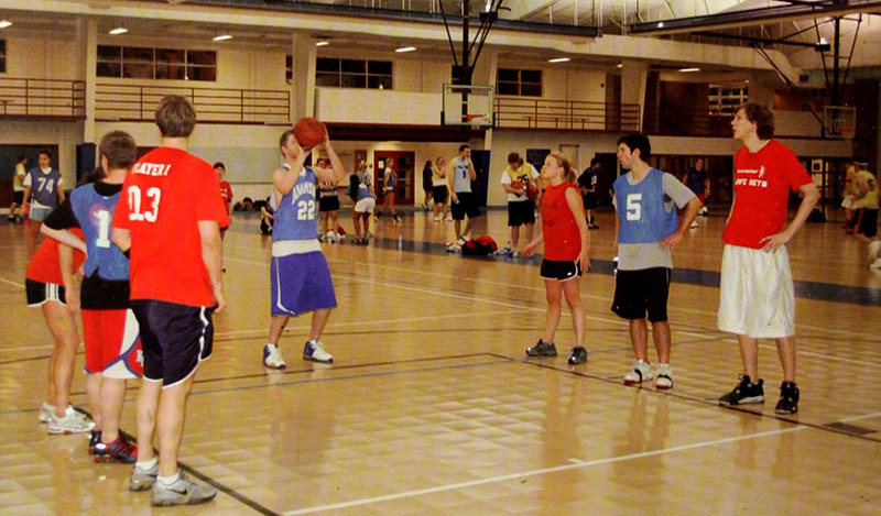 Students play basketball on the KFC gym floor.