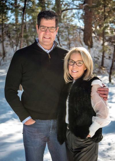 A couple poses together in the snow
