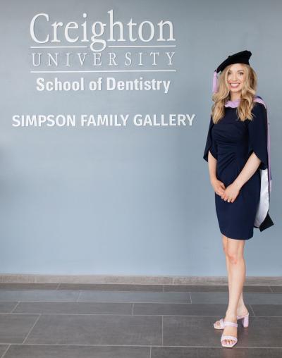 A smiling dental school graduate