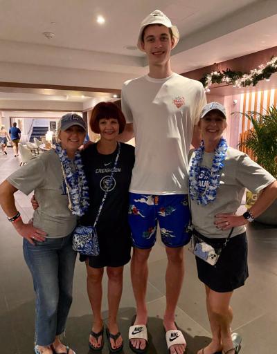 Patty Galas, two of her daughters and Ryan Kalkbrenner smile for a photo.