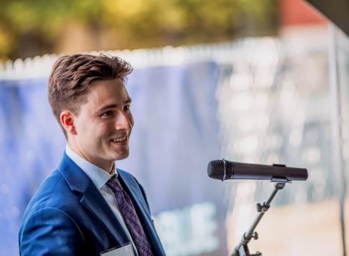 A student speaks in front of a microphone