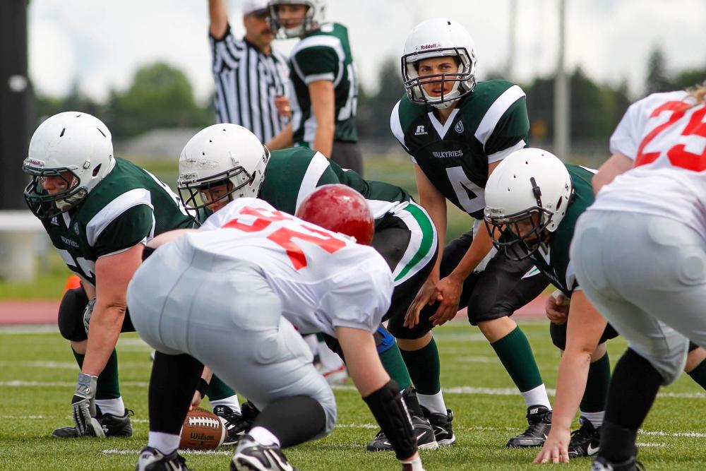 A quarterback lines up under center before the snap