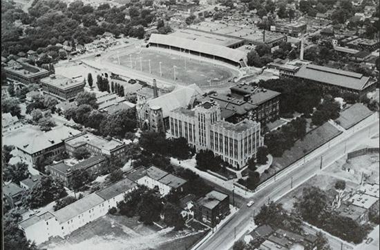 An overhead photo of a campus and its football stadium from 1949