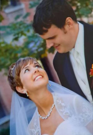 A smiling bride looks up at her husband