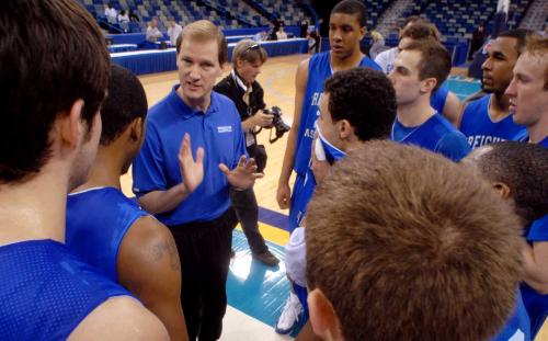 A basketball coach talks to his team in practice