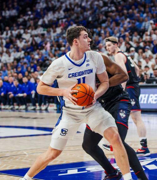 A basketball player makes a move to the hoop