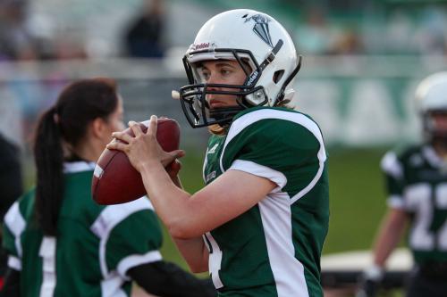 A quarterback warms up before a football game