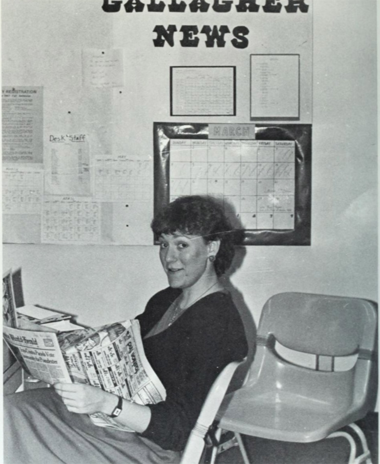 A student working the front desk of Gallagher Hall.