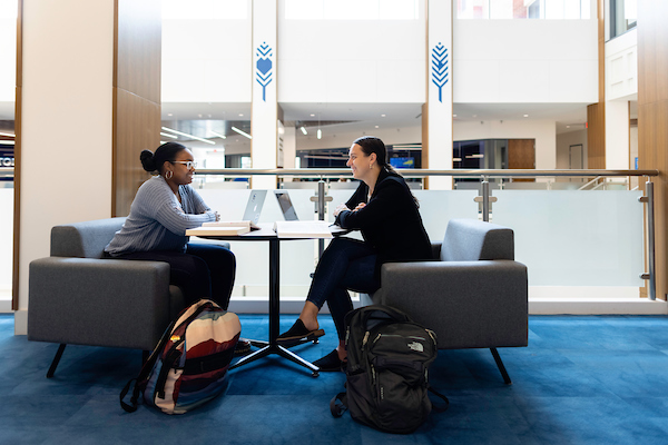 Students sitting and talking in Harper Center.