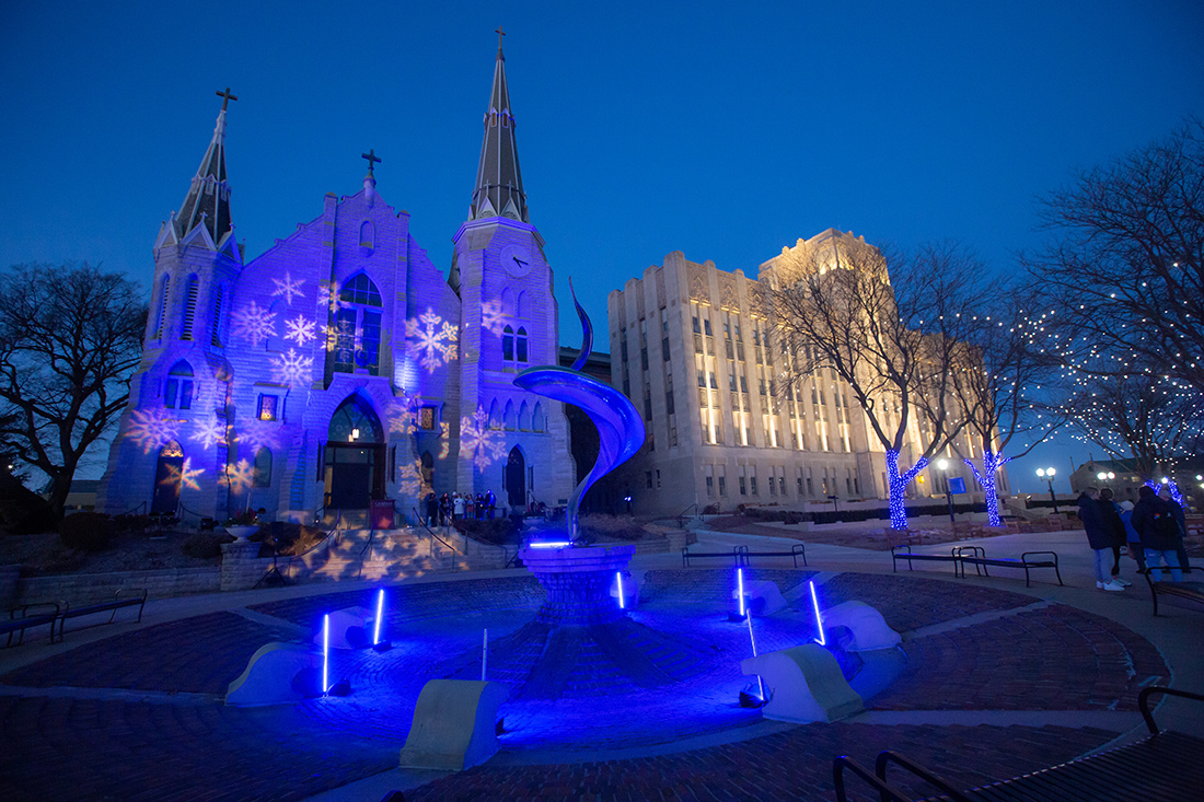 Campus lit up at night with Christmas lights.