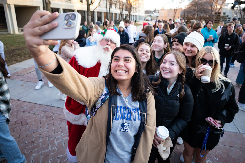 Creighton students pose for a selfie with Santa