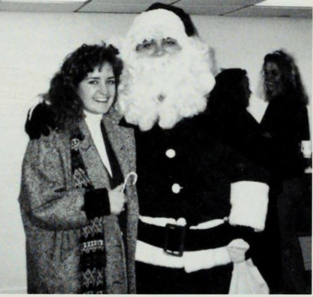 A Creighton student poses with Santa.