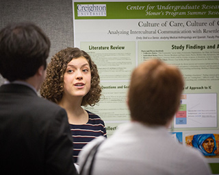 Faculty and students talking in a classsroom