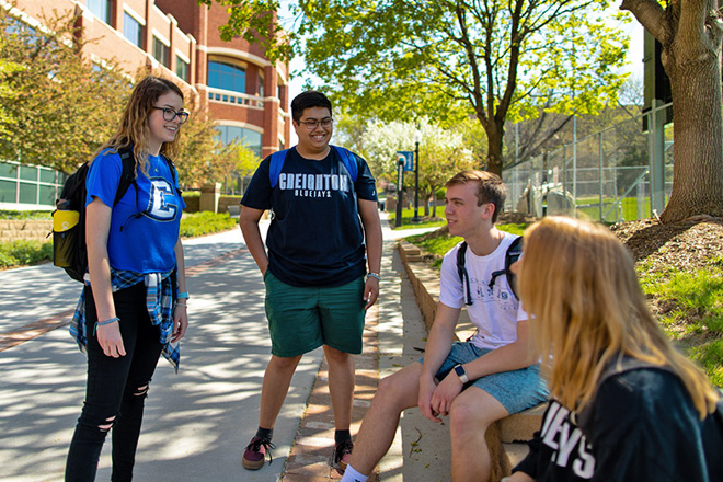 Creighton University students talking to one another