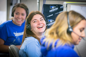 three female Creighton University students working phonathon and laughing