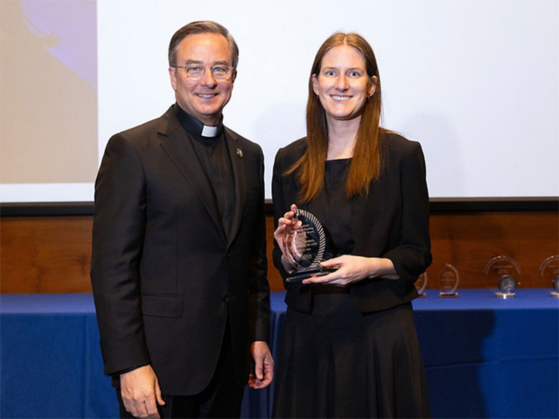 Iverson receiving award from Fr. Hendrickson
