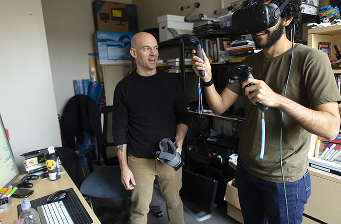 Professor and student work on VR.