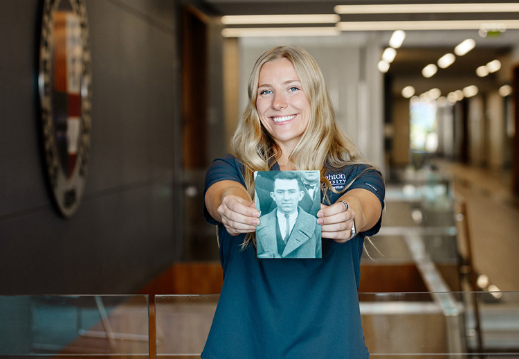 Justine Marbach holding photo of grandfather