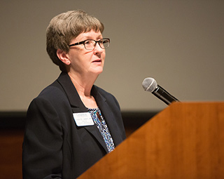 A woman gives a speech at the Hixon-Lied Auditorium.