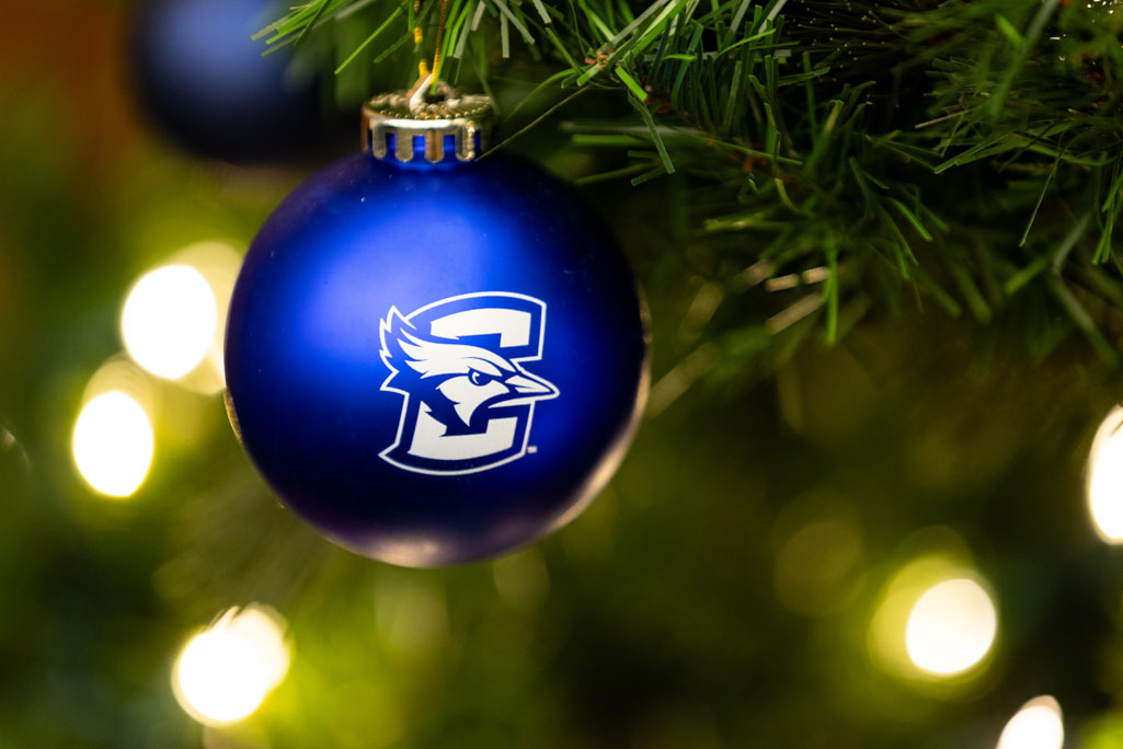 A blue Christmas ornament with the Creighton University logo
