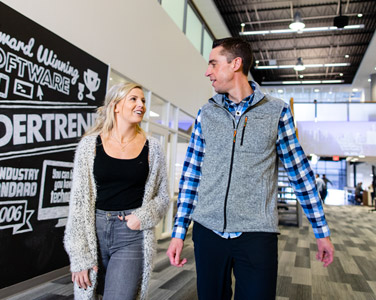 male and female Creighton graduates talking