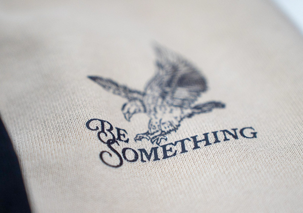 Be Something logo on a shirt.