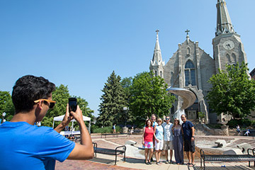 people posing before St. John's on Creighton campus