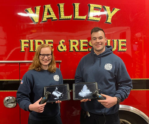 Emma Zeratsky and Josh Hansen, both BSEMS'21, hold the Valley Fire Department&rsquo;s POCUS devices.