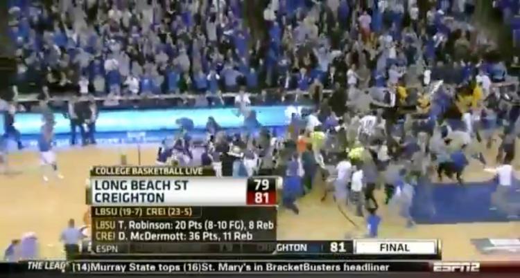 A screenshot of a TV broadcast where fans rush the court