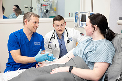 Nursing students talking with patient