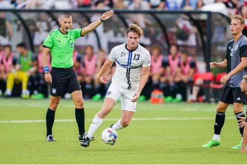 A soccer player controls the ball