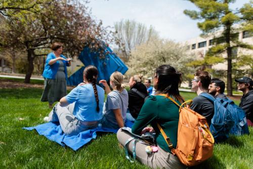 Carol Zuegner teaches a dozen students outside