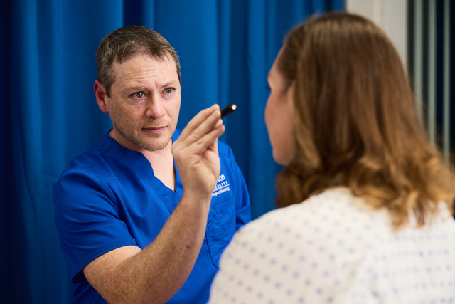 Image of student nurse with patient.