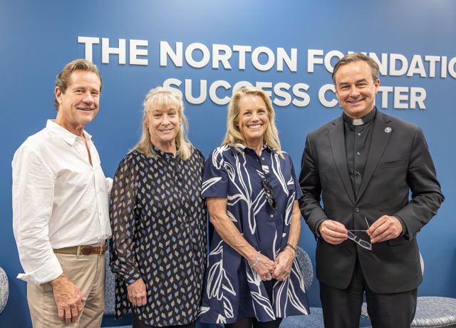 Fr. Hendrickson, right, with members of the Norton family and foundation in The Norton Foundation Success Center.