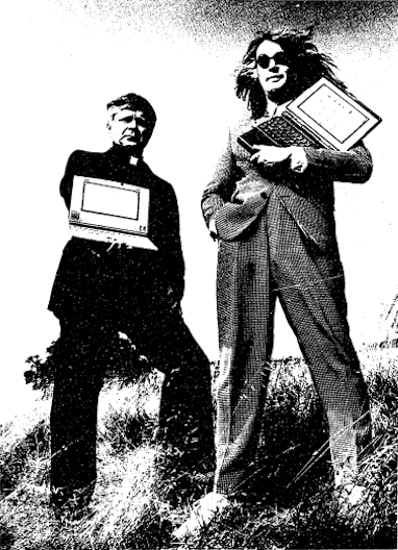 Fr. Don Doll and Todd Rundgren holding their PowerBooks.