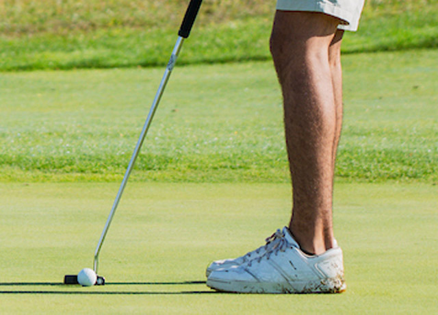 Golfer preparing to putt