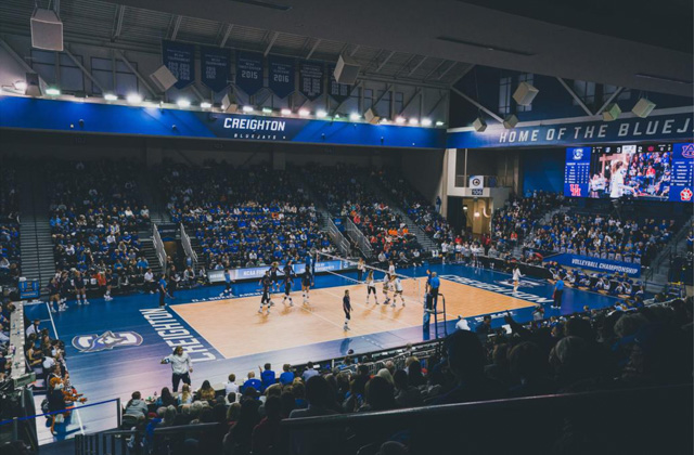 A volleyball court surrounded by a soldout crowd