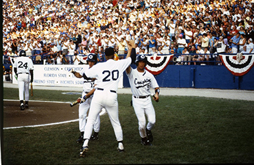 1991 Creighton baseball team high-five after big play.