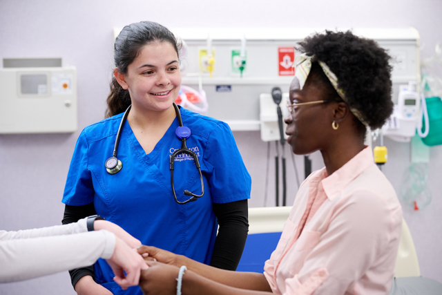 Image of student nurse with patient.
