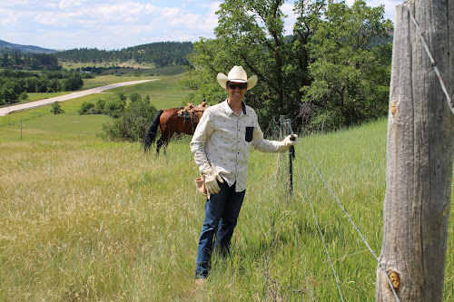 Lee Noel ranch hand in field near fence.