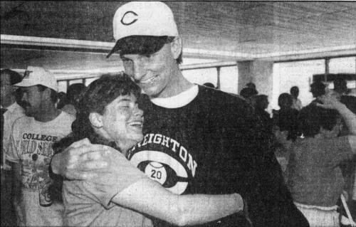 Baseball player hugs fan