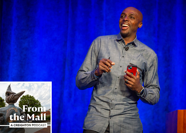 A basketball player speaks on a stage