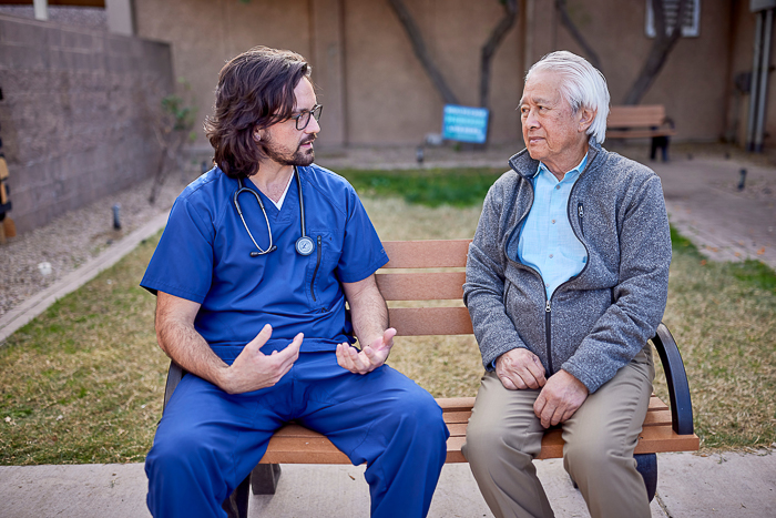 Creighton nurse interacts with a patient. Creighton nurse interacts with a patient.