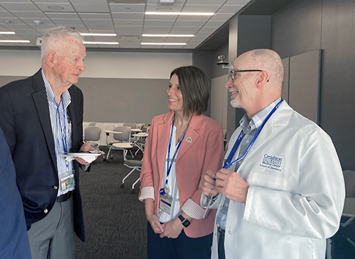 Bill speaks with current dental dean Jillian Wallen and her predecessor, Mark Latta. 