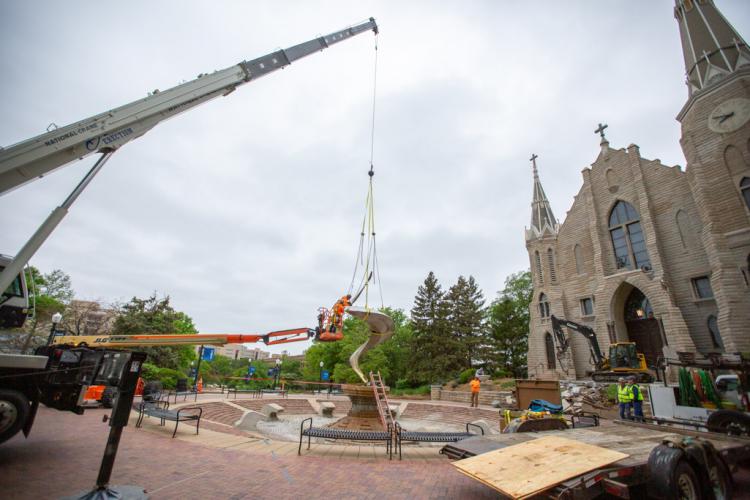 A crane removes the fountain in front of St. John's Church.