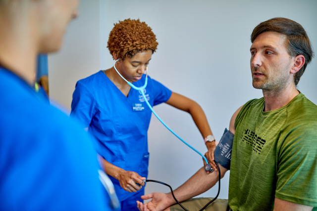 Image of student nurse with patient.